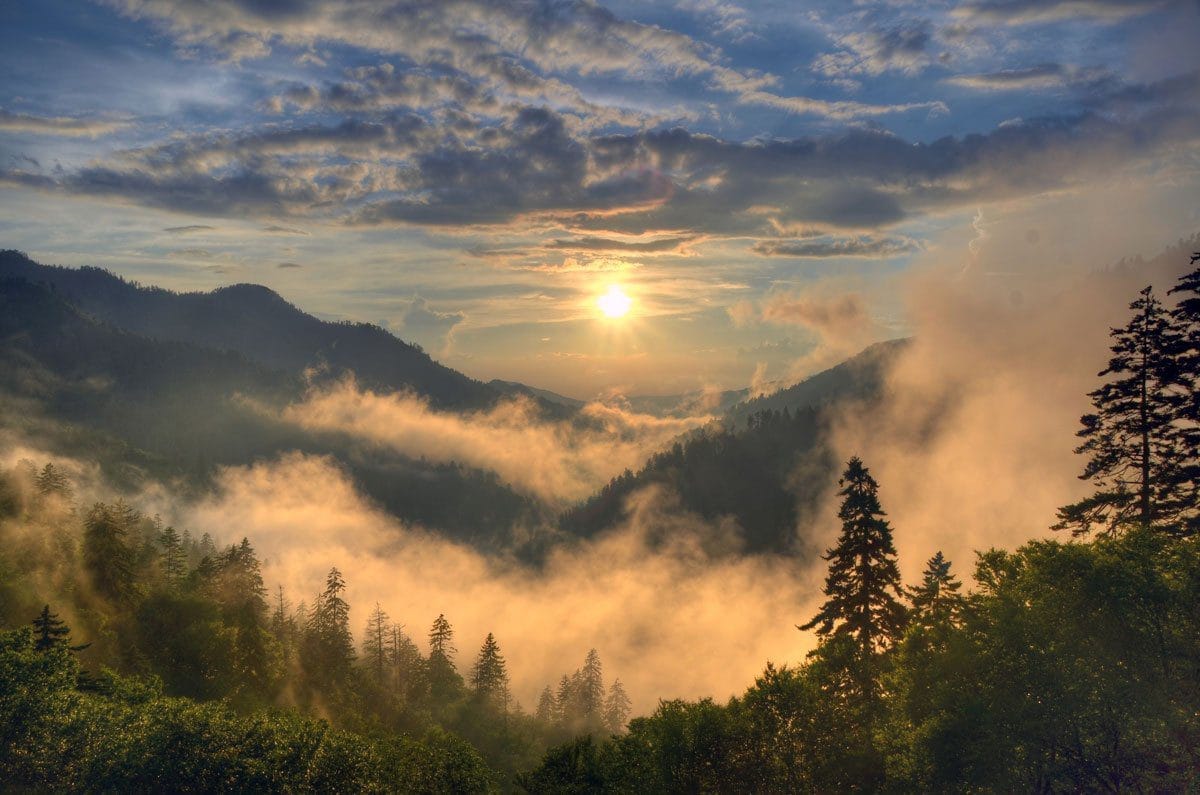 Sunrise over a fog-filled valley